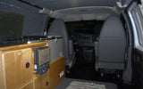 Inside a campervan: custom kitchen with stove, portable heater, fridge, and front seats. Perfect for rv rental!