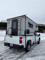 This Fishhook truck camper on a white Chevy Silverado is a great RV rental for snowy Alaskan adventures.