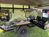 Mission Overland trailer's outdoor kitchen. Sink, stove, and counter space for camping or an RV rental. Ready for adventure!