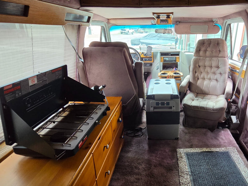  tufted front seats of a vintage RV rental are visible — photo 5