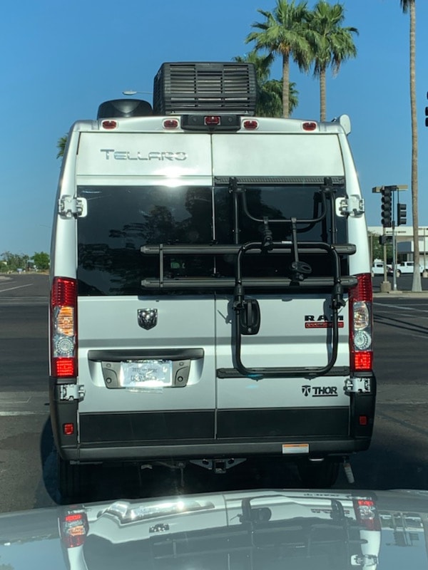 Rear view of a white Thor Tellaro RV rental van (Ram ProMaster chassis), equipped with a bike rack and rear storage unit. — photo 7