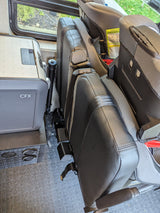 RV rental interior featuring a CFX portable cooler next to a child booster seat, ready for family travel.