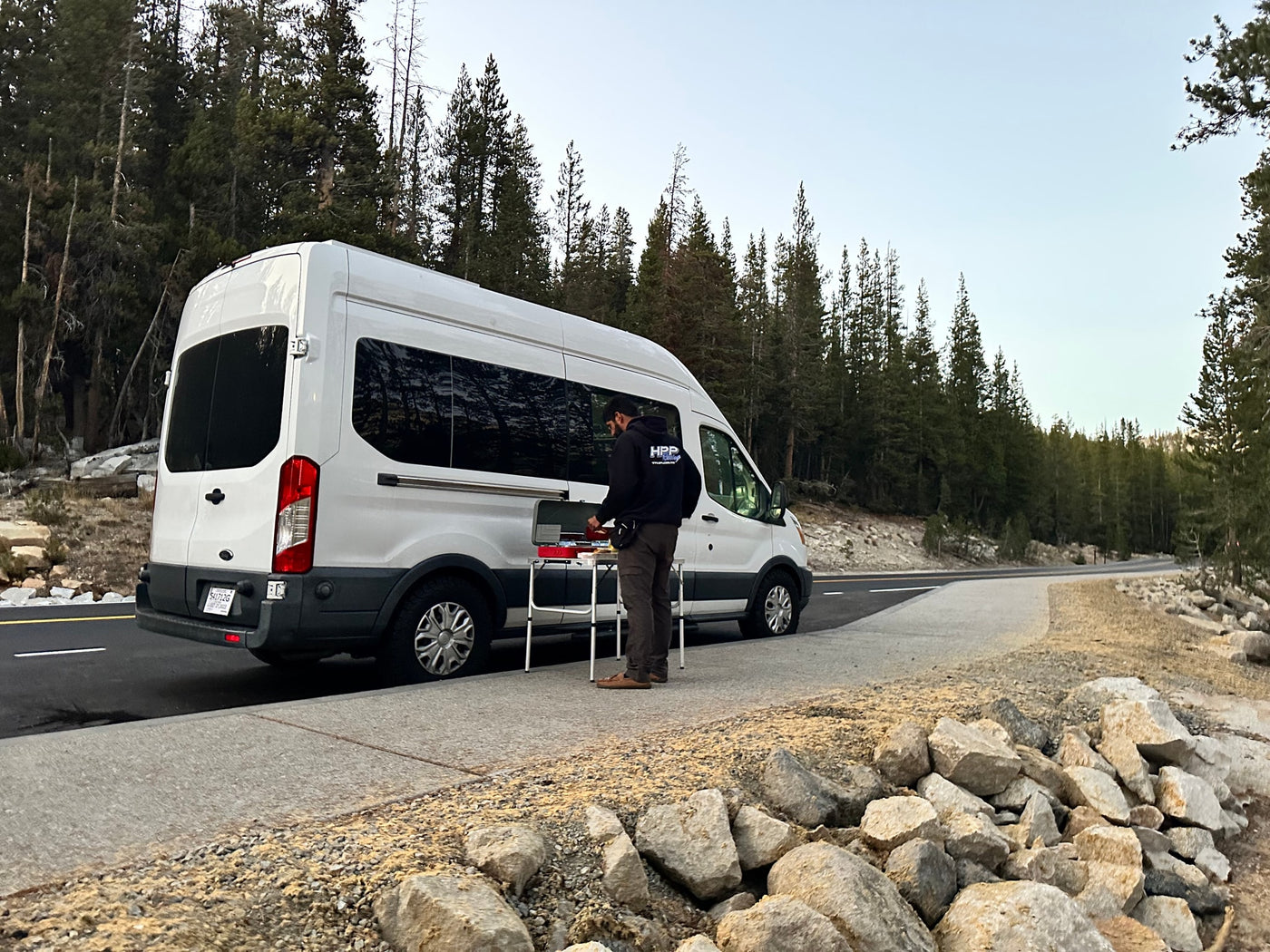  and green overhead cabinets.|White RV rental van by a scenic mountain lake & pine trees at sunset/sunrise — photo 6