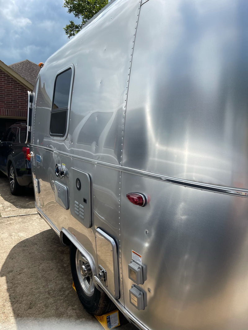 Shiny Airstream RV with utility hookups, parked on a driveway. Could be a great rv rental option for travel. — photo 6