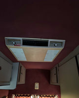 RV rental interior: ceiling-mounted HVAC unit with 'HEIZUNG' controls, vents, and storage cabinets.