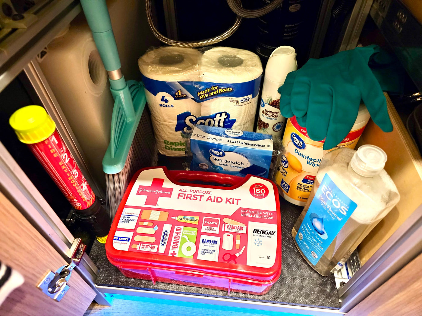 Compact RV rental storage: first aid kit, fire extinguisher, cleaning supplies, and RV-specific toilet paper for travel. — photo 16