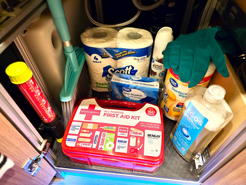 Compact RV rental storage: first aid kit, fire extinguisher, cleaning supplies, and RV-specific toilet paper for travel. — photo 16