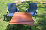 RV rental: YETI camping chairs & portable table on grass, ready for your outdoor adventure.