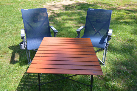 RV rental: YETI camping chairs & portable table on grass, ready for your outdoor adventure.