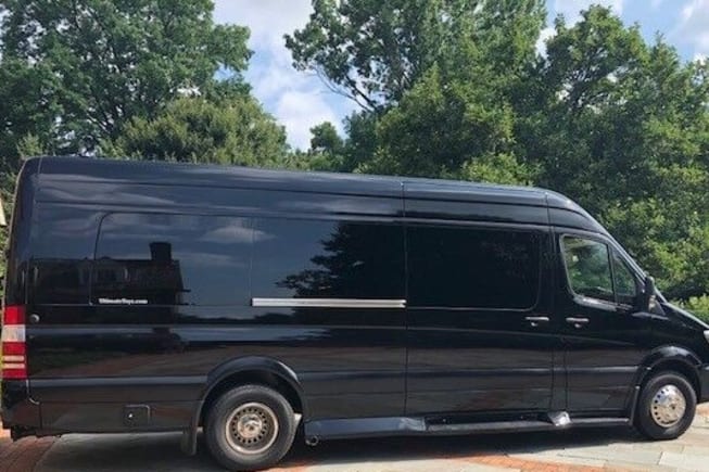 Side view of a black Mercedes-Benz Sprinter van. A versatile vehicle, perfect for luxury travel or an rv rental.