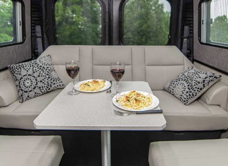  likely ready for an RV rental adventure from California Van Life.|Work on the road! This RV rental offers a cozy mobile office with "ROADTREK" seats — photo 4