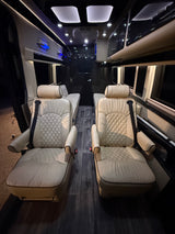 Luxury RV rental interior with cream quilted seats, dark wood floor, and ambient lighting. Perfect for comfortable travel.