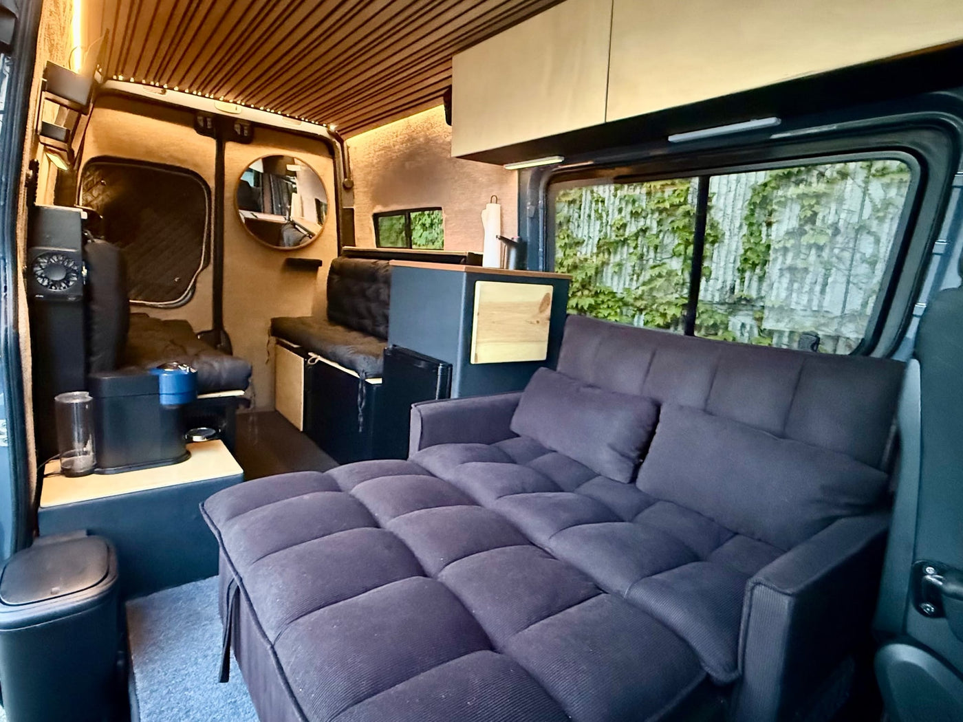  well-appointed interior for your next adventure.|Cozy RV rental interior: extended sofa bed — photo 12