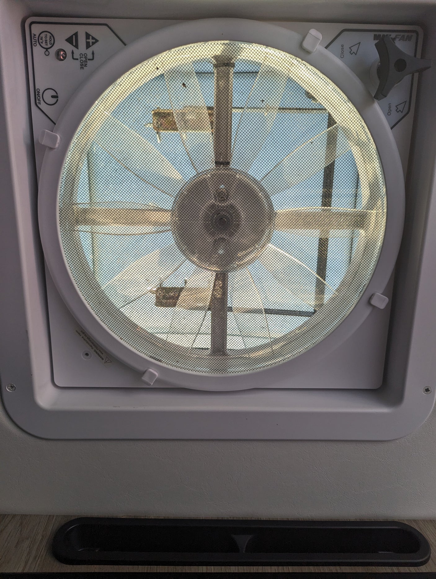 MaxxAir vent fan inside an RV rental, showing the control panel for air circulation & temperature settings.