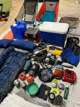 Camping & overlanding gear laid out: Helinox chairs, cooler, power, cooking, sleep, and dive essentials for your RV rental adventure.