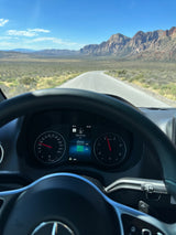 RV rental road trip: Dashboard view on a desert highway, showing 88°F, 20mph, & engine oil OK, with scenic mountains.