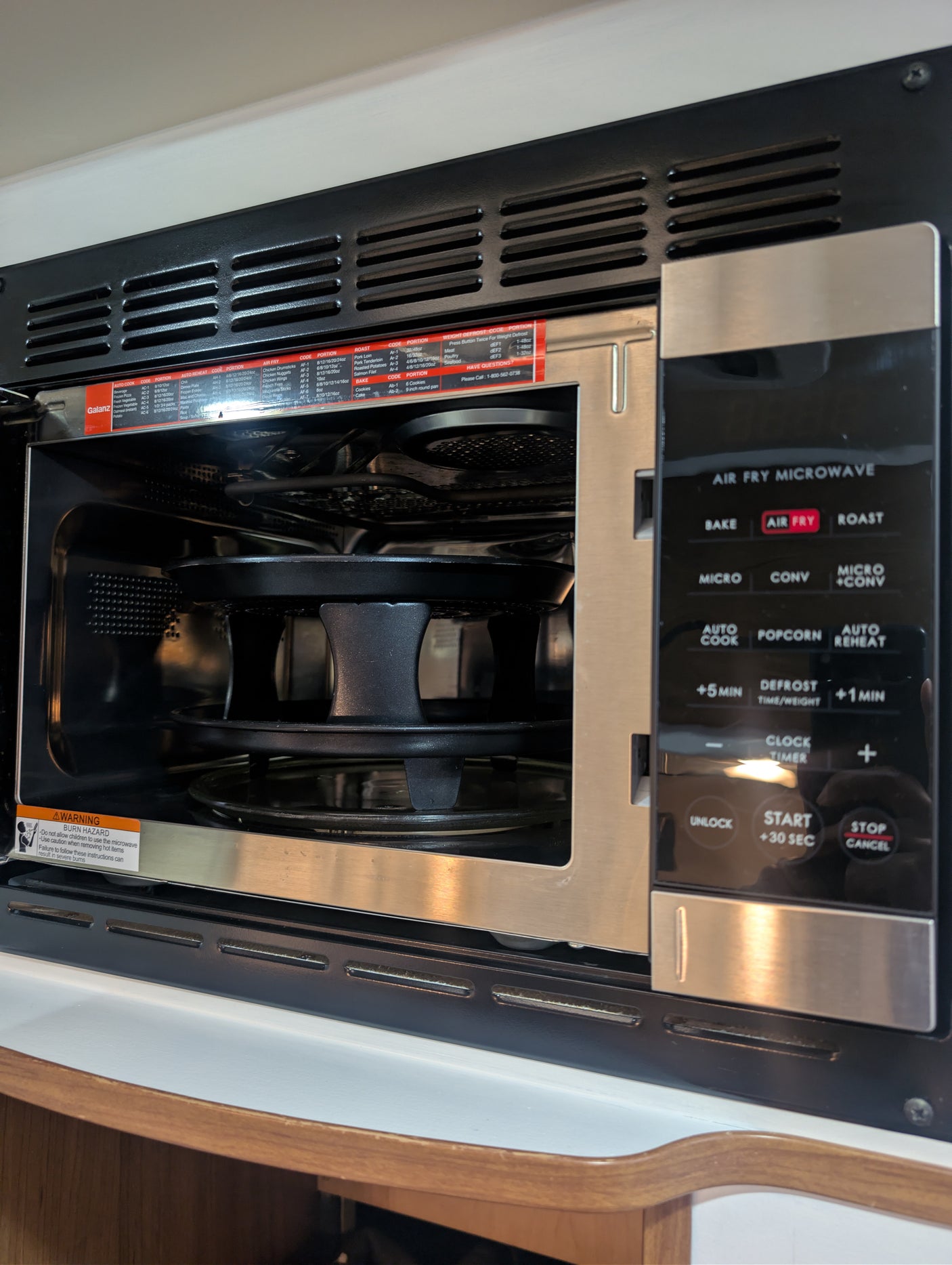 This compact air fry microwave, featuring bake, roast, and convection modes, is perfect for an rv rental kitchen. Includes safety warning.