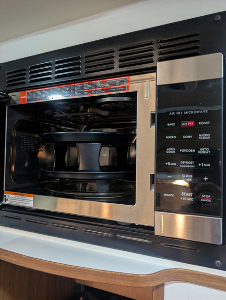 This compact air fry microwave, featuring bake, roast, and convection modes, is perfect for an rv rental kitchen. Includes safety warning.