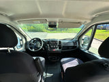 Spacious RV rental cockpit, featuring the dashboard, steering wheel, and comfortable front seats.
