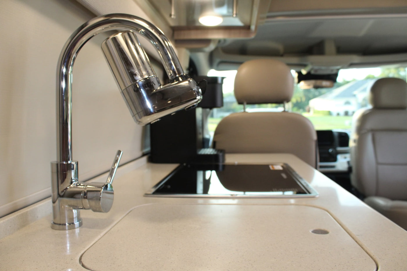 and compact bathroom.|Modern RV rental bedroom featuring a large — photo 8