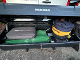Hitch-mounted cargo box for RV rental, open and full of GSI Outdoors camping gear and bags.