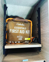 Cabela's First Aid Kit and portable light stored in an RV rental cabinet, essential for travel safety.