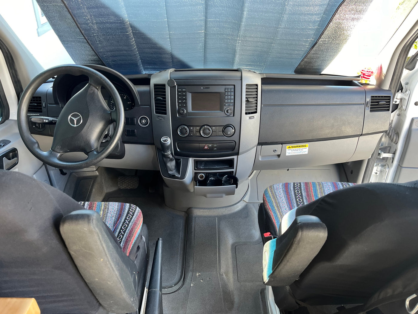  and prayer flags. Perfect for your next road trip!|Custom RV rental interior with comfy benches — photo 6