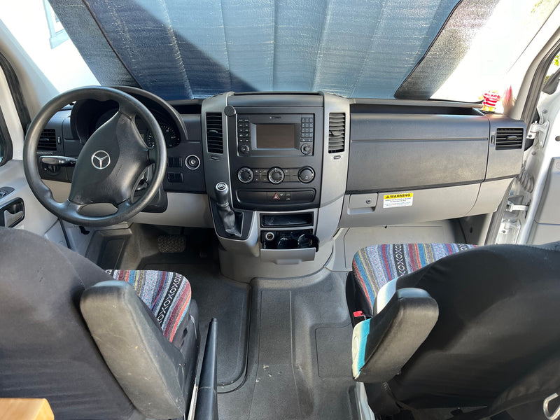  and prayer flags. Perfect for your next road trip!|Custom RV rental interior with comfy benches — photo 6