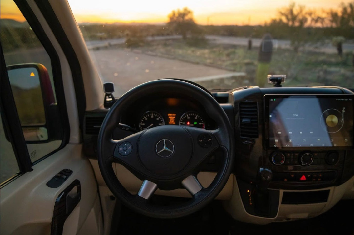  parked by a scenic lake and mountains.|Inside an RV rental: driver's view of the Mercedes-Benz dashboard — photo 6