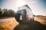 Mercedes Sprinter camper van, perfect for your next RV rental adventure. Parked in a sun-drenched field.