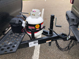 RV rental Bushwhacker trailer hitch area with propane tank, battery box, and towing connections. Essential camping setup.