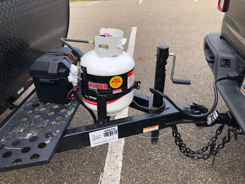 RV rental Bushwhacker trailer hitch area with propane tank, battery box, and towing connections. Essential camping setup. — photo 13
