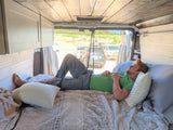 Relaxing inside a cozy RV rental, enjoying the view from a converted van.