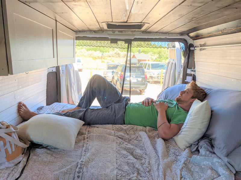  & dining table with two mugs.|Private outdoor shower for your RV rental adventure: patterned curtains — photo 10