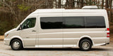 Side view of a beige Roadtrek E-trek rv rental van, equipped for comfortable travel.