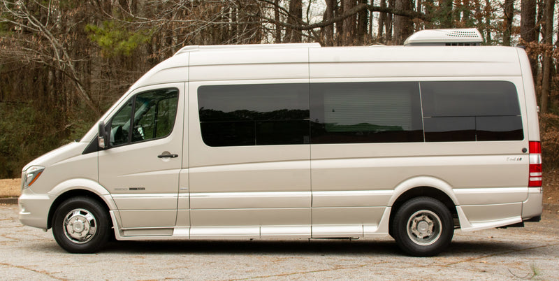 Side view of a beige Roadtrek E-trek rv rental van, equipped for comfortable travel. — photo 3