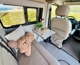  is parked overlooking a sunny ocean. Perfect for road trips.|Experience scenic tranquility in this RV rental. Twin beds offer comfort