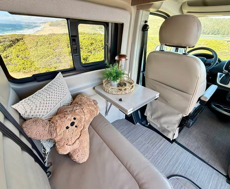  is parked overlooking a sunny ocean. Perfect for road trips.|Experience scenic tranquility in this RV rental. Twin beds offer comfort — photo 10