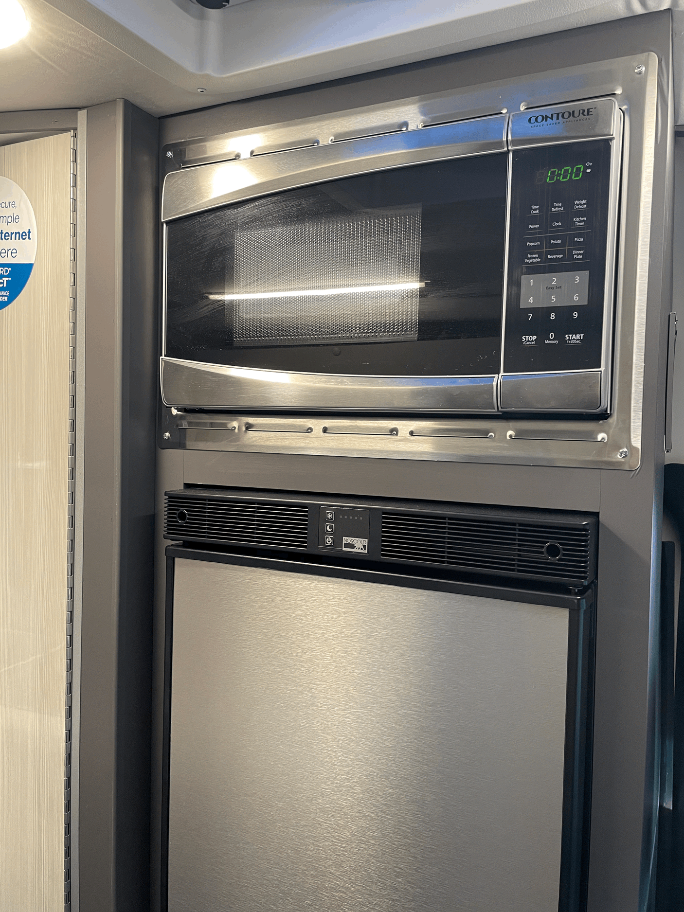 A Contoure microwave and Norcold refrigerator integrated into an rv rental, showcasing compact kitchen appliances for efficient living.