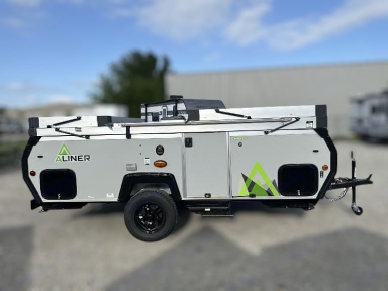  offering a scenic campsite view.|RV rental: A-frame camper interior with wood-look floor