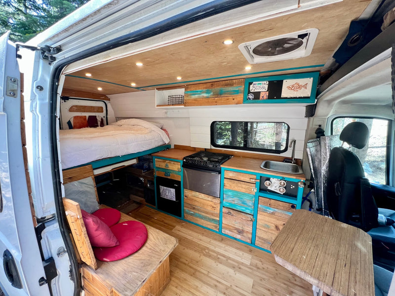  & natural wood finishes.|This custom RV rental features a cozy bed — photo 3