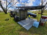This RV rental (an off-road camper trailer) provides an ideal outdoor camping setup with an awning, chairs, and generator.