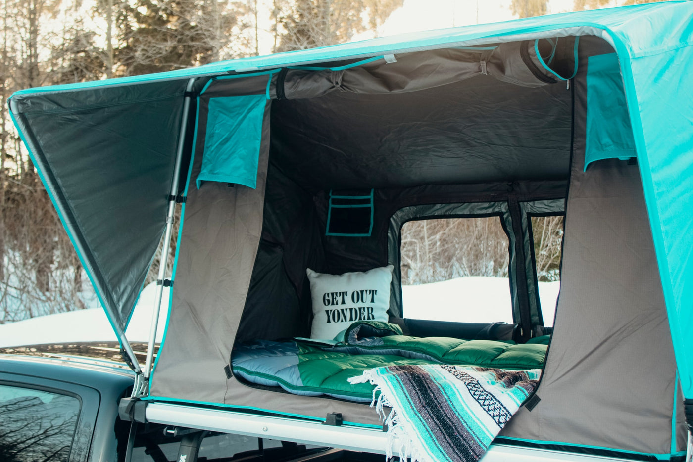 Get ready for adventure! This cozy rooftop tent on a truck offers an ideal **RV rental** experience for winter travels. — photo 5