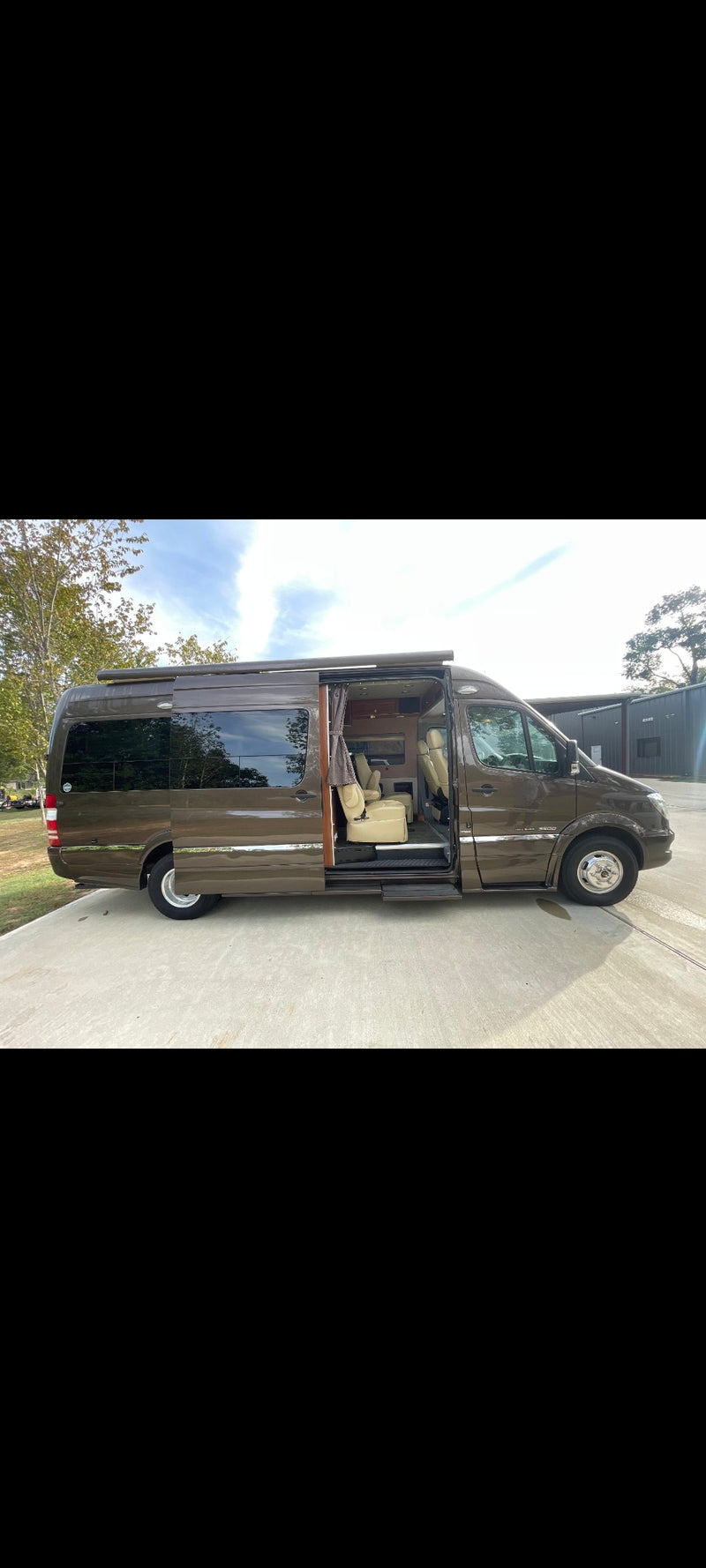 Brown luxury Mercedes Sprinter RV rental with open side door revealing plush beige interior. — photo 8