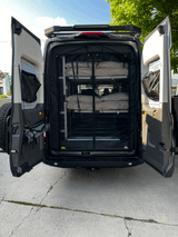 Rear view of an RV rental camper van, revealing a clever bunk bed system & ample storage, perfect for adventure travel.