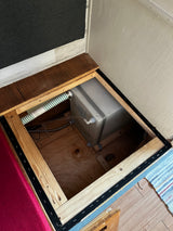 RV rental under-bed storage revealing a freshwater tank, plumbing, and wiring, neatly tucked away for compact living.