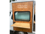 RV rental with a functional outside foldable table on the camper van's side, perfect for outdoor dining/prep.