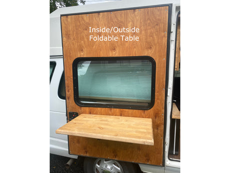 RV rental with a functional outside foldable table on the camper van's side, perfect for outdoor dining/prep.