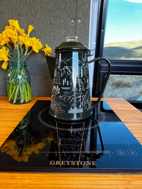 RV rental kitchen: Dark green coffee percolator on a Greystone induction cooktop, with fresh daffodils. Perfect for travel!