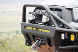 Close-up of a rugged Toyota's front bumper with LED lights, bull bar, and a Factor 55 recovery hook, ready for off-road RV rental fun.
